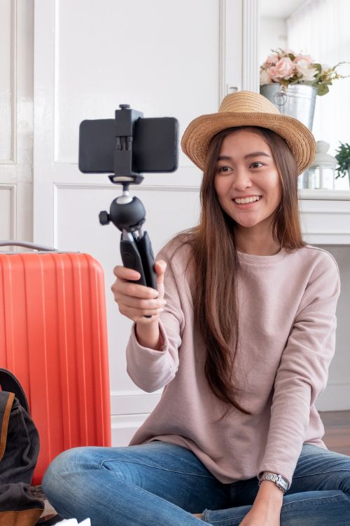 An influencer taping themselves with a phone and gimbal.